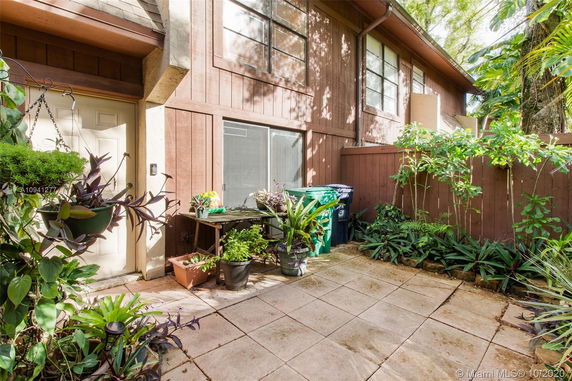 Exterior view of a house with plants and patio area.