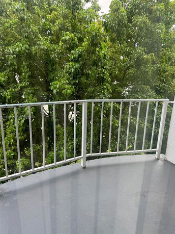 View of surrounding trees from a balcony or terrace.