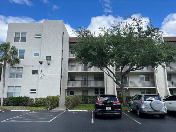 Front view of a multi-story residential building with balconies.