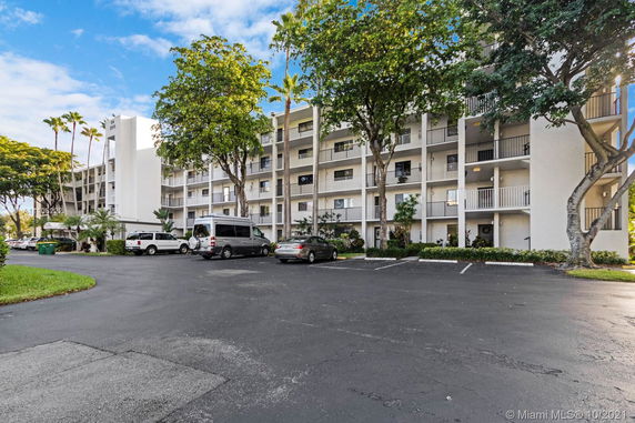 Front view of a multi-story residential building with balconies.