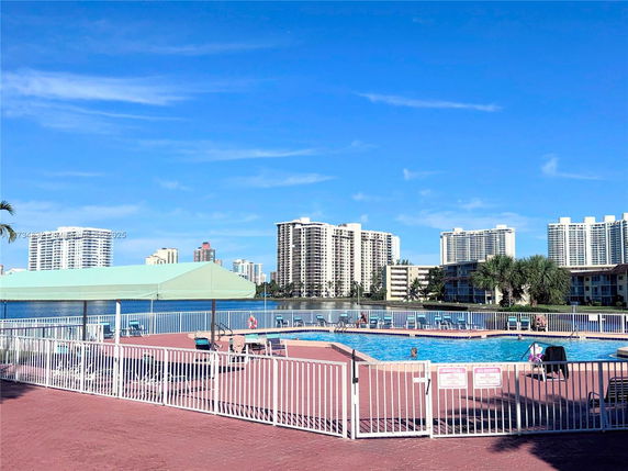 Outdoor swimming pool with high-rise buildings in the background.
