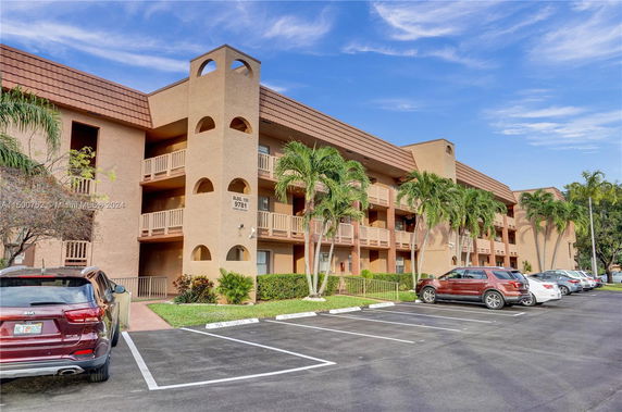 Front view of a multi-story apartment building with balconies.