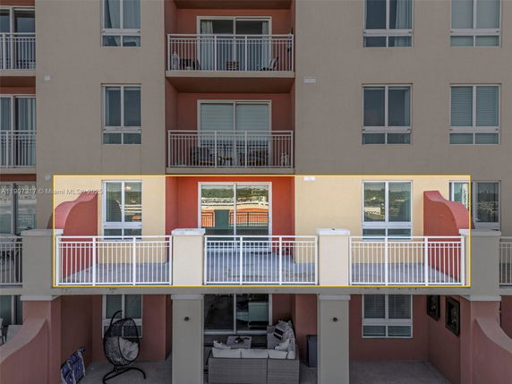 View of a multi-story building facade with balconies.