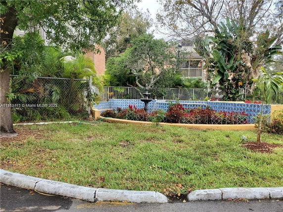 View of outdoor garden area with a fountain and plants.