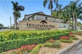 Front view of Hollywood Parc condominiums with signage and landscaping.