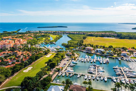 Panoramic view of a coastal area with marina and residential buildings.