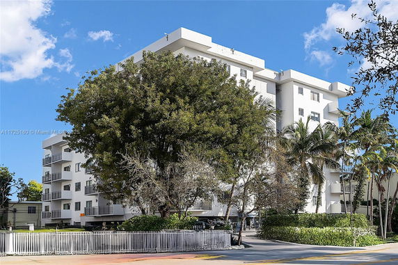 Front view of a multi-story building with balconies.