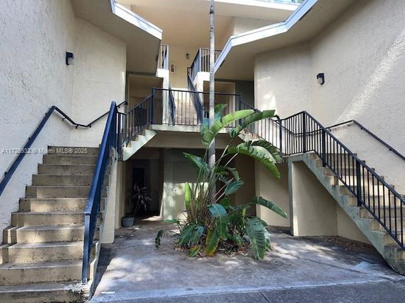 Front view of a multi-level building with staircases leading to the upper floors.