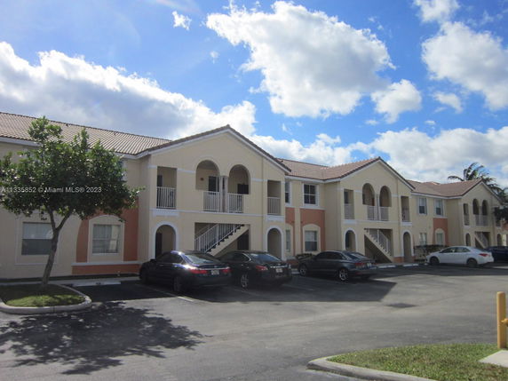 Front view of a two-story residential building with arched balconies.