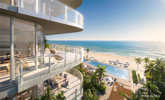 Panoramic view of a beachfront building with balconies overlooking the ocean.