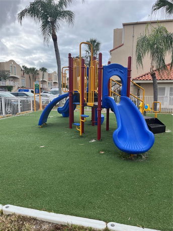 Outdoor playground with slides and climbing structures.