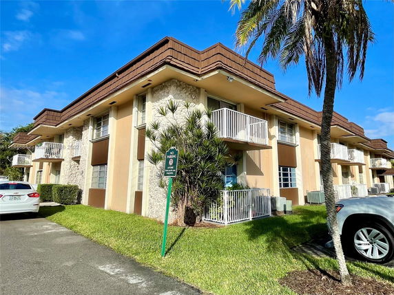 Front view of a multi-story residential building with balconies.