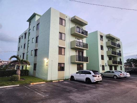 Front view of a multi-story apartment building with balconies.
