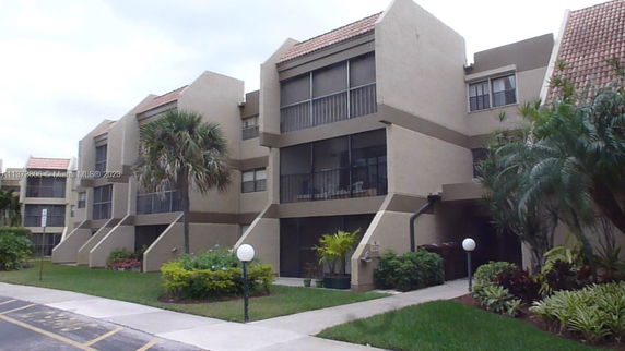 Front view of a multi-story residential building with balconies.