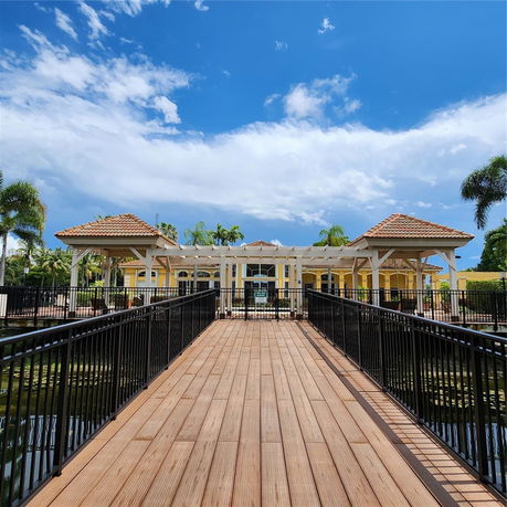 Front view of a building with a wooden walkway and pergola-style roof.