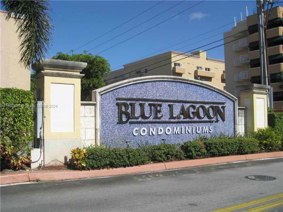 Front view of Blue Lagoon Condominiums sign with building in background.