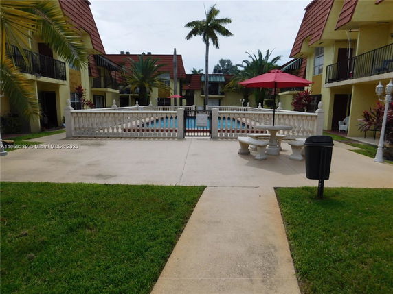Outdoor area with a swimming pool surrounded by residential buildings.