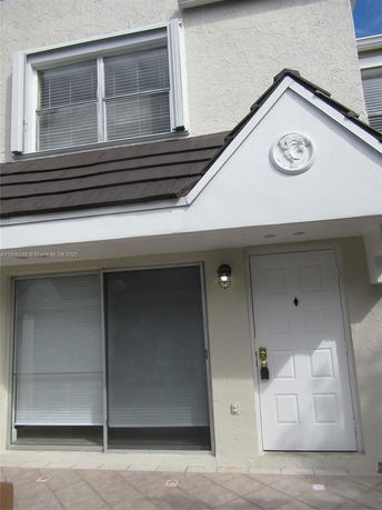 Front view of a house with a white door and window.
