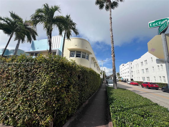 Front view of a multi-story building on a city street corner.