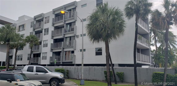Front view of a multi-story residential building with balconies.