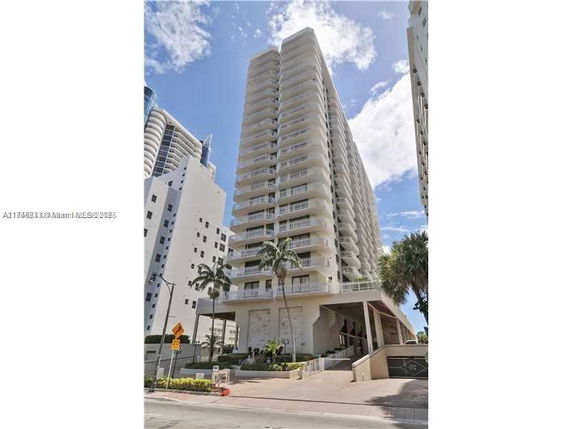 Front view of a tall residential building with balconies.