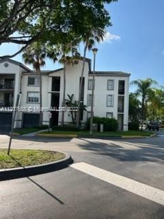 Front view of a multi-story apartment building with balconies.