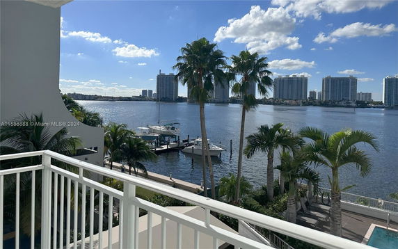 View from a balcony overlooking water and distant buildings.