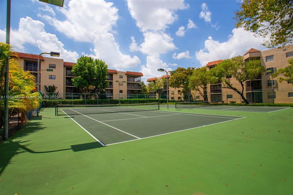 Tennis court surrounded by residential buildings.