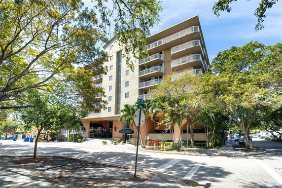 Front view of a multi-story apartment building with balconies.