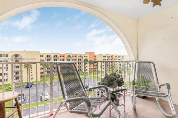 Balcony view overlooking a complex with multi-story buildings.