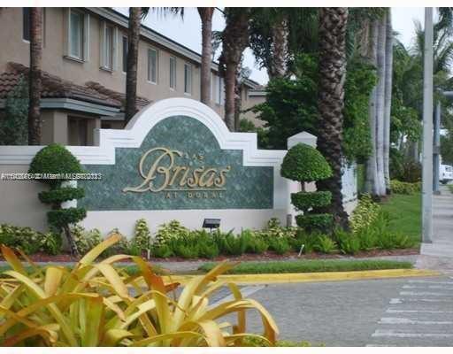 Front view of a residential building with an entrance sign reading 'Brisas at Doral'.