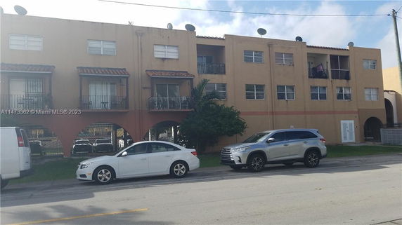 Front view of a multi-story apartment building with balconies.