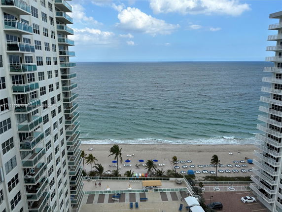 Panoramic view of the ocean and beach from a high-rise building.