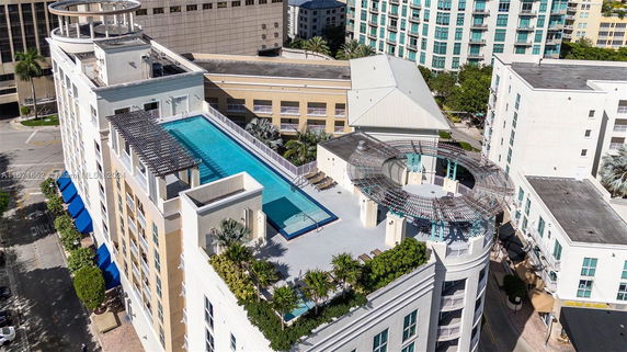 Rooftop with a swimming pool and leisure area on top of a multi-story building.