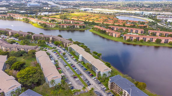Aerial view of a residential area with multiple apartment buildings surrounding a lake.
