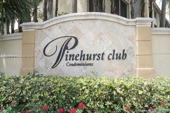 Signage for Pinehurst Club Condominiums displayed outdoors.