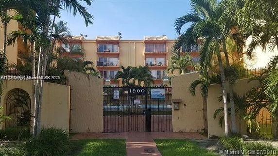 Front view of a multi-story residential building with gated entrance.