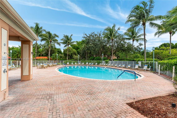 Outdoor swimming pool area with surrounding deck and lounge chairs.