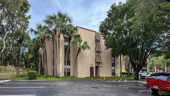 Front view of a multi-story residential building with distinctive window design.
