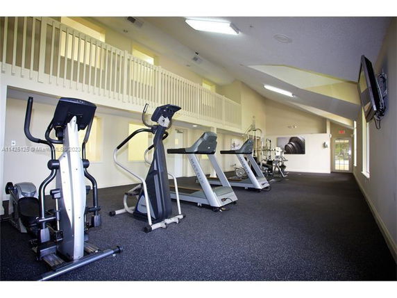 Gym area with exercise equipment in a clubhouse.