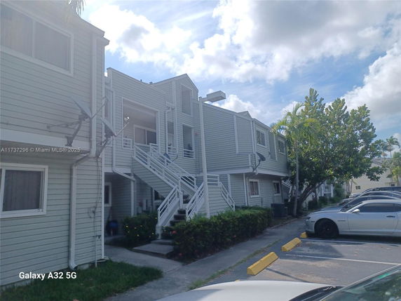 Front view of a two-story residential building with external staircases.