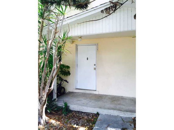 Front view of a house entrance with a white door and small porch.