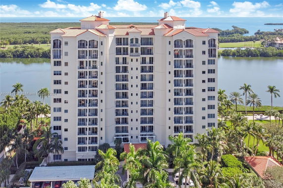 Front view of a high-rise residential building with multiple balconies.
