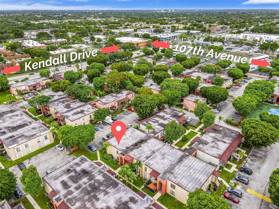 Aerial view of a residential area with multiple buildings and surrounding streets labeled Kendall Drive and 107th Avenue.