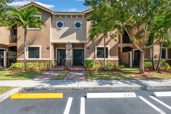Front view of a two-story townhouse with distinct windows and entries.