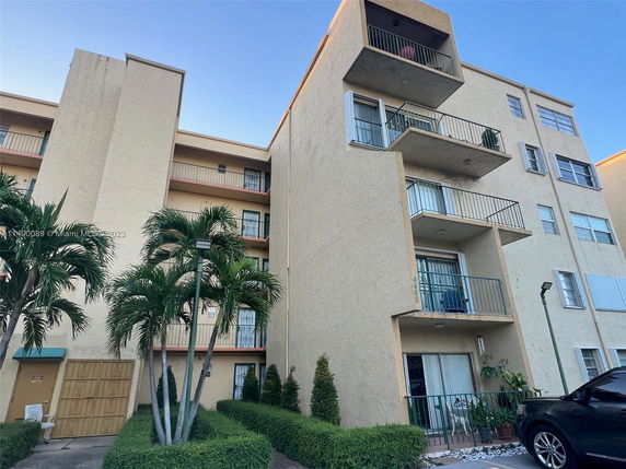 Front view of a multi-story residential building with balconies.