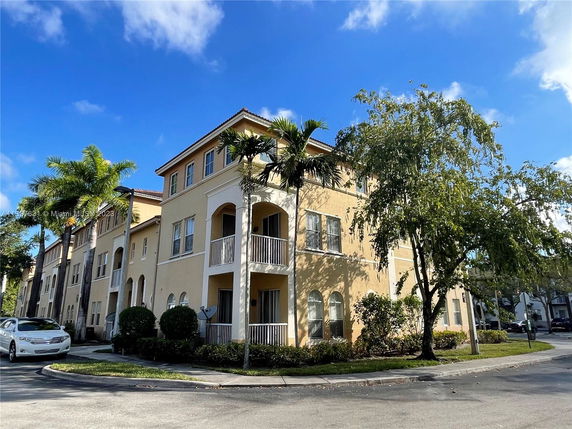 Front view of a multi-story residential building with balconies.