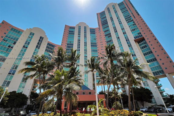 Front view of a high-rise building with multiple floors and large windows.