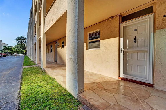 Front view of a multi-story building with a covered entryway.