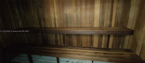 Wood-paneled sauna room with benches.